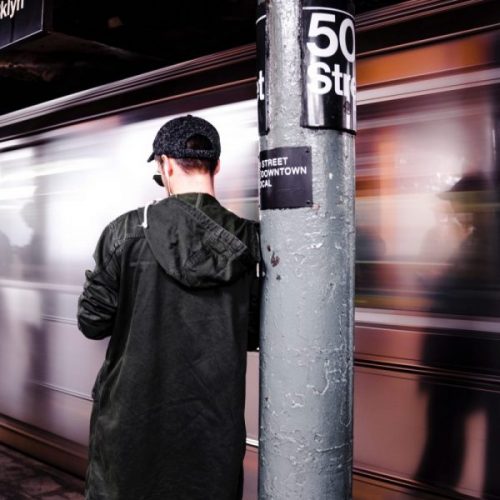 Brooklyn NY features a man standing outside a subway.